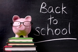 Image of a piggy bank wearing glasses standing on books in front of a blackboard with the words back to school written on it